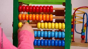 Child Learning to Count with Calculating Tool (Abacus)
