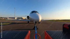 Private Jet Aircraft Towing on Airport Ramp, View from Tow Truck.