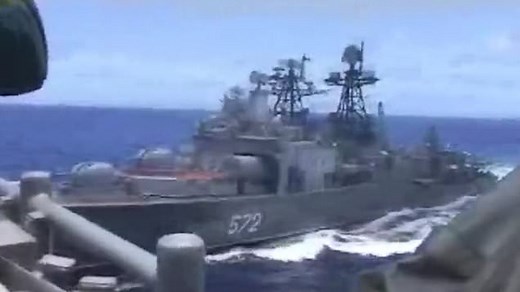 Russian sailors sunbathe as warships narrowly avoid colliding