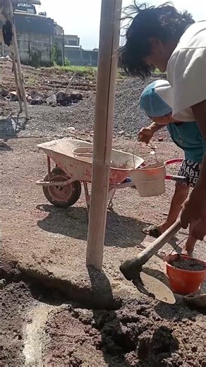 Traditional construction method: mixing and carrying cement and sand
