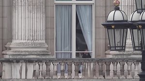 A royal peek-a-boo: Charlotte and Louis look through Palace window