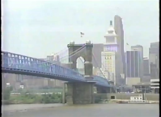 The Philadelphia Phillies at the Cincinnati Reds. Intro. July 21st, 1990. 36 years ago. The wire to wire Reds were 9 games ahead in NL West standings. 57-32. Intro shows cranes for the First Financial Tower and the nearly complete skyline shifting Scripps Center Downtown.