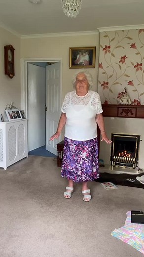 Elderly Woman Dancing in Cozy Living Room