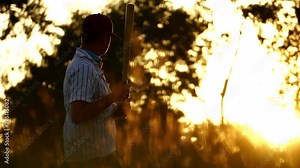 Men's baseball practice hitting a baseball with the light of sunset footage slow motion