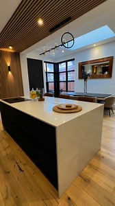 Situated within an extensively renovated edwardian property in the heart of newcastle. Our breakfasting kitchen project features extended height tall cabinetry in an earthy mix of dark steel, Halifax oak and contemporary oak slatted panelling finishes provide the backdrop against a Carrara marble effect quartz encased island with cascading end-panels. Counter height seating to the rear of the island and a complimenting open dry-bar, are the perfect additions to the adjoining dining and entertain