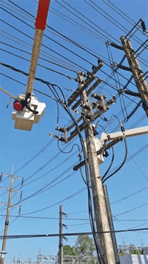 clip-3997264705-electrical-lineman-cutting-high-voltage-power-line