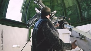 A professional engineer observer of a solar coronagraph at a solar observatory is working with a telescope. Scientific observation of the solar corona by scientists