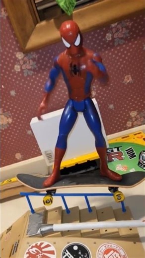 spider man dances on skateboard on the rail.