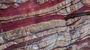 High quality animation of drilling operations subsurface or down hole view with drill bit and drill string penetrate rock formation layer while drill cutting circulating out through annulus