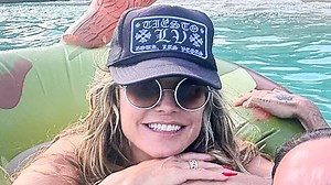 Heidi Klum goes topless as she takes swim at beach during tropical getaway