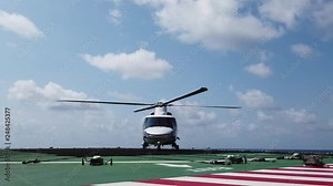 Helicopter landing on a helideck of an offshore oil rig, service travel to oil and gas platform and drilling rig in offshore locations