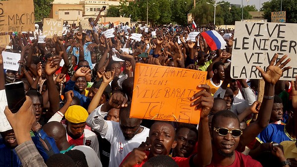 Protesters celebrate the ousting of Niger's president during coup attempt