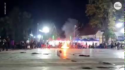 Festival goers had to scatter right before the flying lantern carrying a firework fell down and exploded at a festival in Thailand. | USA TODAY Video
