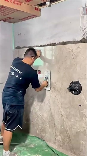 Two workers install large marble tiles on building walls #shorts #construction #wall