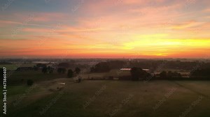 Soaring in the early morning sky, the camera captures a moment of nature's magic. As the sun begins its ascent, it sets the heavens ablaze with a medley of colors, turning the sky into a dramatic