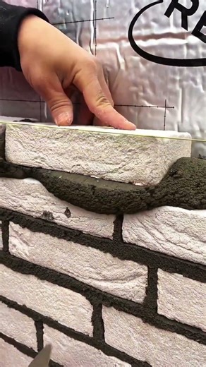 Yellow string line guiding precise brick alignment in masonry work