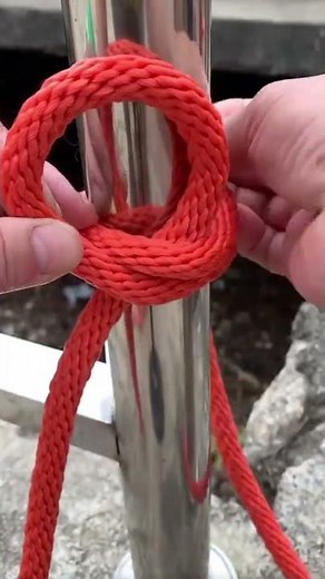 the process of tying the orange bogie rope to the stainless steel pole with a strong tie.