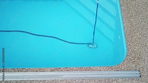 Cleaning the home pool. Pre-season pool preparation. Cleaning the pool after winter. The worker pulls coarse dirt out of the water using a collecting net.