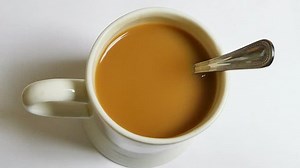 Mug of tea with teaspoon stirring itself