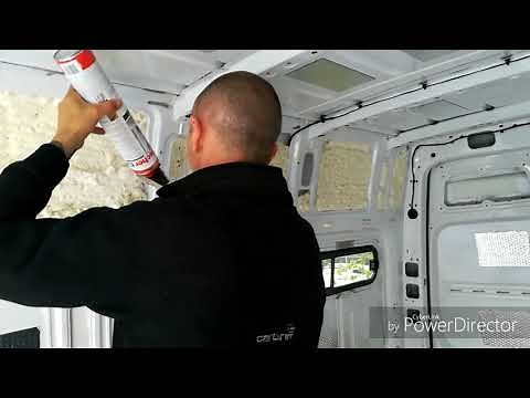 Using expanding foam to insulate small voids in our van.