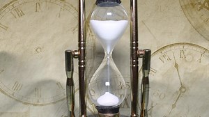 Download Close up of a transparent hourglass. Time concept for free