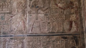 Ancient Egyptian hieroglyphics at the Karnak Temple Complex in Luxor, Egypt, tilt down. Stock Video