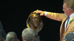 Kevin Greene caresses the mane of his Hall of Fame bust