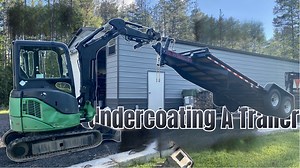 Undercoating a trailer using a mini excavator setup