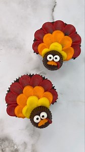 Gobble Gobble 🦃 Create a cute turkey cupcake that’s sure to wow your guests! 🤎 Fill cupcake liners with your favorite chocolate cake mix and insert a rectangular folded up piece of foil on each side of the top of the cupcake to make a point. Bake as usual. 🧡 With the point at the bottom, use tip #12 to pipe a row of red buttercream dots across the top, then use the side of a piping tip to pull down the dot to create feathers. Repeat with a row of orange and then yellow, working your way down 