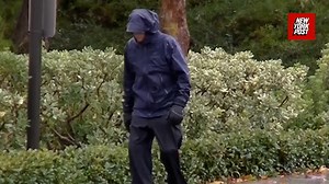 Mitt Romney's brother strolls through rain days after estranged wife found dead