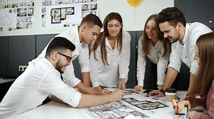 Young architects working on a blueprint - Free Stock Video