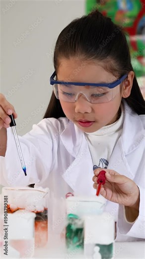 Young Asian Girl in Lab Coat Conducting Chemistry Experiment with Dry Ice