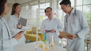 Asian middle age man medical teacher and students in white coat talking about human skeleton anatomy, explain structure of bones and joints in classroom. Medical, education, anatomy concept