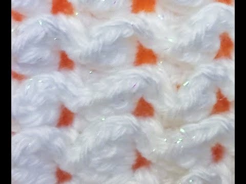 Airy, embossed crochet pattern with repeating wave motifs.