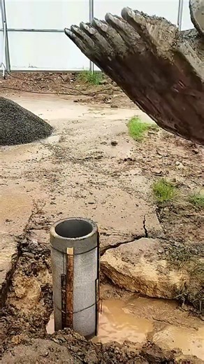 Real Engineerings | Engineering & Technology & Gadgets & DIY on Instagram: "A perfect demonstration of water displacement in construction. ​This clip illustrates a common challenge in civil engineering: backfilling in saturated, waterlogged ground. ​We see a precast concrete structure (likely a manhole section or caisson) set in a muddy excavation. As the excavator dumps a large volume of clean aggregate (gravel) into the pit, the gravel displaces an equal volume of water. ​With nowhere else to 