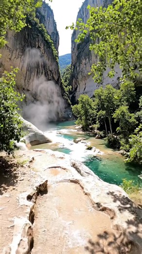 In Greece, this hidden gem in Epirus is a mythical river source featuring crystal-clear icy waters, lush plane tree forests, and towering white limestone canyon walls. #greece #greecetravel #greecetiktokers #greecehiddengems #travel