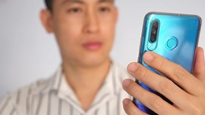 Asian young Man Freelancer Using mobile phone, Looking at the Screen.His Desk in Home Office Studio Working 4K. facetime and studying Online