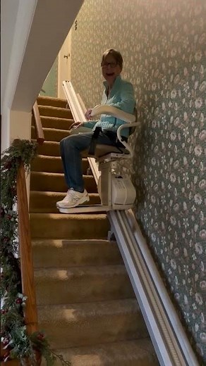 Smiling Riding the Harmar Pinnacle SL300 Stairlift - Detroit MI Installation by HomePro Mobility