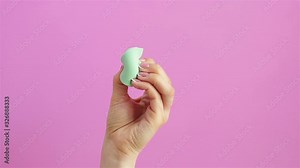 woman hand squeezing beauty sponge blender