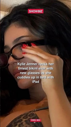 Kylie Jenner rocks her tiniest bikini ever with new glasses as she cuddles up in bed with iPad #shor