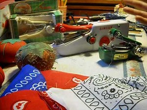 Singer Stitch Sew Quick and Manual Hand Held Sewing Machines and a Tied Quilt