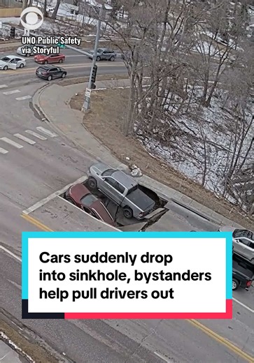 Two cars were suddenly swallowed by a sinkhole in Omaha, Nebraska on Monday as they waited at a red light. Several bystanders rushed to the aid of the drivers, pulling them out of their vehicles and directing traffic away from the area, according to Omaha Police. #news #nebraska #traffic #vehicle #car