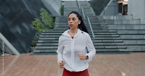 Woman, fitness and running in rain for workout, cardio exercise or outdoor training by stairs. Active female person, athlete or runner in sports motivation, sprint or lose weight in an urban town