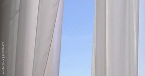 Window with curtains and a view of the sky. Conceptual romantic story of the room and open Windows.