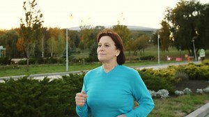 Old woman running in a park in the morning - Free Stock Video