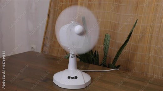 Desk fan operating with oscillating movement in three different positions demonstrating airflow for cooling and air circulation