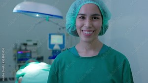 Portrait of a smiling nurse in the operating room and a smiling doctor woman taking off the surgical face shield in a hospital operating room. with hospital operating room lighting equipment.