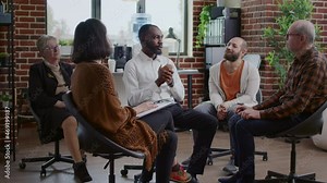 African american man sharing addiction story with group of people at aa therapy meeting. Adult having conversation with psychologist and patients in circle at rehabilitation session.