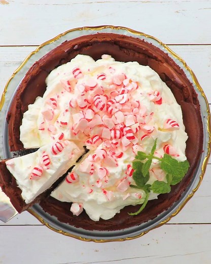 Thanks to a fluffy layer of Whipped Peppermint Cream, there's no need to worry about cracks in this festive cheesecake! Get the recipe: https://trib.al/Y4sNM0D | Southern Living