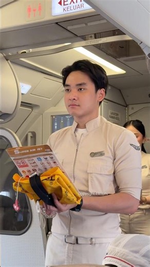 Handsome flight attendant safety demonstration